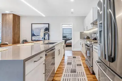 a kitchen with white cabinets and a stainless steel refrigerator at 3 Bdrm 3 Full Bath Tower View walk up in Cincinnati