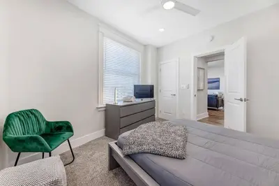 a bedroom with a bed and a chair and a desk at 3 Bdrm 3 Full Bath Tower View walk up in Cincinnati