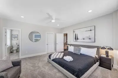 a bedroom with a large bed and a couch at 3 Bdrm 3 Full Bath Tower View walk up in Cincinnati