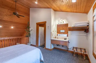 a bedroom with a bed and a sink at The Lodge at Fields of Home in Millersburg