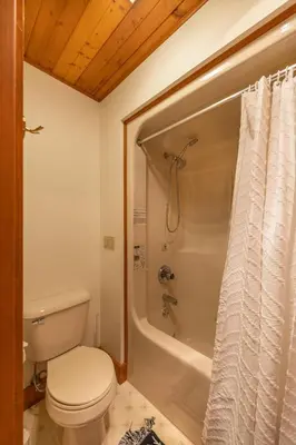 a bathroom with a toilet and a bath tub at The Lodge at Fields of Home in Millersburg
