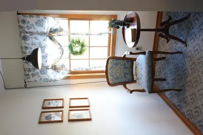 a mirror hanging on a wall next to a window at The Kennedy House in Grayson