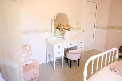 a white dressing table with a mirror and a chair at The Kennedy House in Grayson