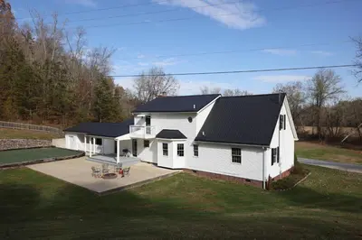 a white house with a black roof at The Kennedy House in Grayson