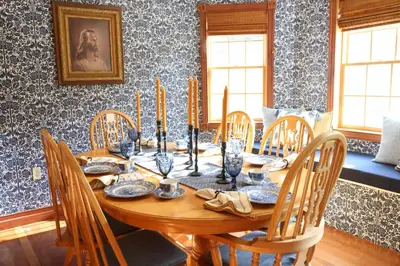 a dining room with a wooden table and chairs at The Kennedy House in Grayson