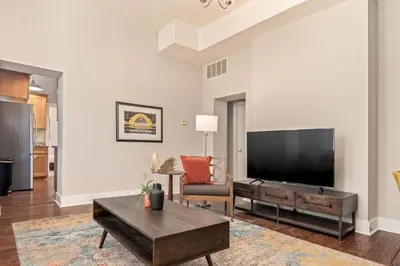 a living room with a large flat screen tv at 3-BR Soccer Stadium- Fast Drive to OTR - Downtown in Cincinnati
