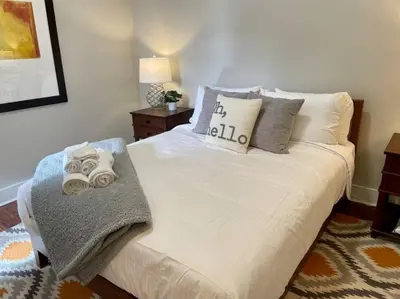 a bedroom with a white bed with towels on it at 3-BR Soccer Stadium- Fast Drive to OTR - Downtown in Cincinnati