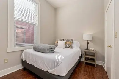 a white bedroom with a bed and a window at 3-BR Soccer Stadium- Fast Drive to OTR - Downtown in Cincinnati