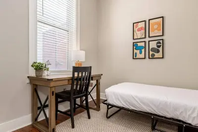 a bedroom with a desk and a bed and a window at 3-BR Soccer Stadium- Fast Drive to OTR - Downtown in Cincinnati