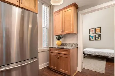 a kitchen with a stainless steel refrigerator and a window at 3-BR Soccer Stadium- Fast Drive to OTR - Downtown in Cincinnati