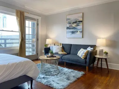 a bedroom with a bed and a couch and a window at Explore Downtown and Mount Adams with River Views in Cincinnati