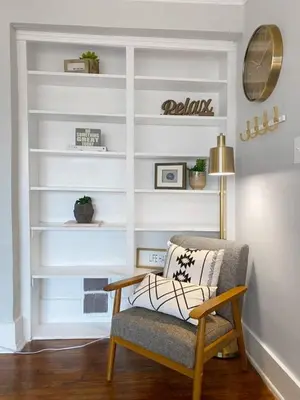 a living room with a chair and shelves at Explore Downtown and Mount Adams with River Views in Cincinnati