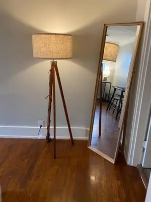 a floor lamp in a room with a mirror at Explore Downtown and Mount Adams with River Views in Cincinnati