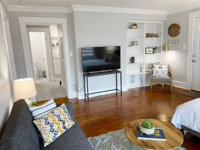 a living room with a couch and a tv at Explore Downtown and Mount Adams with River Views in Cincinnati