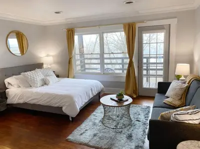 a bedroom with a bed and a couch and a table at Explore Downtown and Mount Adams with River Views in Cincinnati