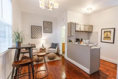 a kitchen and living room with a table and chairs at Stylish Flat in Walkable Downtown w Parking in Cincinnati