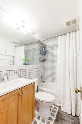 a bathroom with a toilet and a sink and a shower at Stylish Flat in Walkable Downtown w Parking in Cincinnati