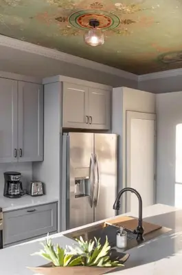 a kitchen with white cabinets and a ceiling with a sink at Parlor - Explore OTR and DT from Restored 1894 Italianate in Cincinnati