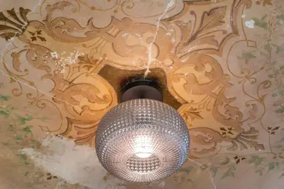 a light hanging from a ceiling in a room at Parlor - Explore OTR and DT from Restored 1894 Italianate in Cincinnati
