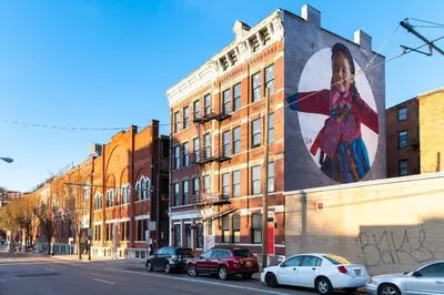 a building with a large painting on the side of it at Parlor - Explore OTR and DT from Restored 1894 Italianate in Cincinnati