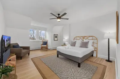 a living room with a bed and a couch at Cozy 2.5BR near Zoo - Hospitals - UC - Free Parking in Cincinnati