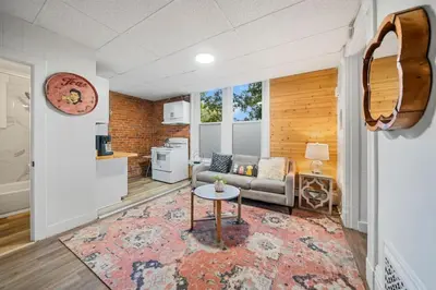 a living room with a couch and a table at Cozy Studio with Parking - Near UC, Zoo, Downtown in Cincinnati