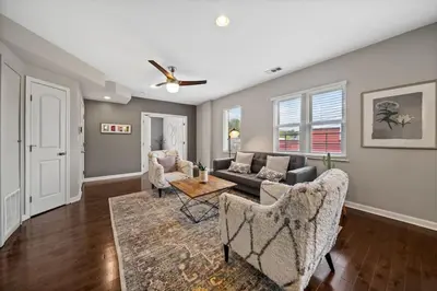 a living room with a couch and a table at Classy 2BR Condo Near City Centre - OTR, UC, Zoo in Cincinnati