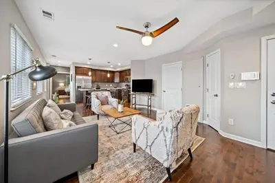 a living room with a couch and a table at Classy 2BR Condo Near City Centre - OTR, UC, Zoo in Cincinnati