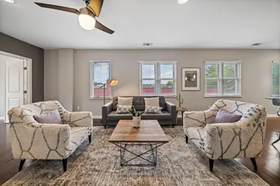 a living room with two chairs and a table at Classy 2BR Condo Near City Centre - OTR, UC, Zoo in Cincinnati