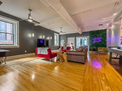 a living room with a couch and a table at The Historic Lyric Penthouse with Private Rooftop in Cincinnati