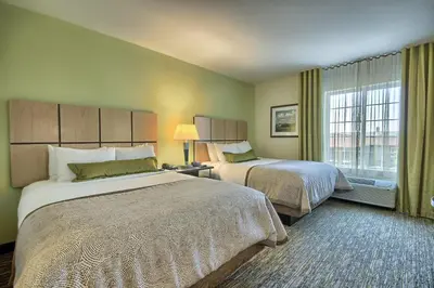 a hotel room with two beds and a window at Candlewood Suites Columbus - Grove City by IHG in Grove City