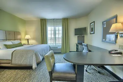 a hotel room with a bed and a table at Candlewood Suites Columbus - Grove City by IHG in Grove City