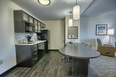 a kitchen with a table and a counter top at Candlewood Suites Columbus - Grove City by IHG in Grove City