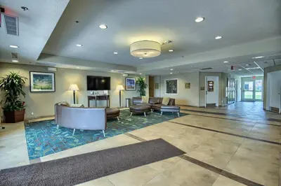 a lobby with couches and chairs in a building at Candlewood Suites Columbus - Grove City by IHG in Grove City