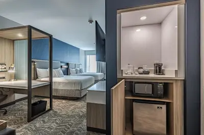 a hotel room with a bed and a television at SpringHill Suites by Marriott Fort Wayne Southwest in Fort Wayne