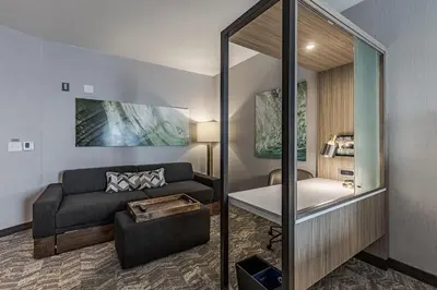 a living room with a couch and a table at SpringHill Suites by Marriott Fort Wayne Southwest in Fort Wayne