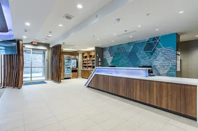 a lobby with a reception desk in a building at SpringHill Suites by Marriott Fort Wayne Southwest in Fort Wayne