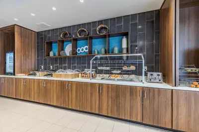 a buffet line in a restaurant with food at SpringHill Suites by Marriott Fort Wayne Southwest in Fort Wayne