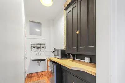 a kitchen with a sink and a counter with a microwave at Library Square Suites in Toledo