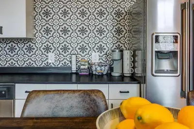 a kitchen with a counter with a bowl of oranges at Good Vibes Loft - DT CLE Walk To All The Stadiums in Cleveland