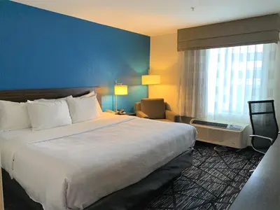 a hotel room with a large bed and a window at SureStay by Best Western Cambridge in Cambridge