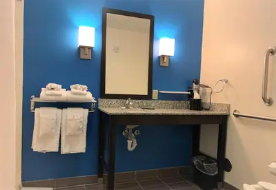 a bathroom with a sink and a mirror at SureStay by Best Western Cambridge in Cambridge