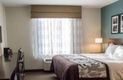 a hotel room with a bed and a window at SureStay by Best Western Cambridge in Cambridge