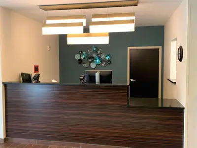 a lobby with a reception desk in a building at SureStay by Best Western Cambridge in Cambridge