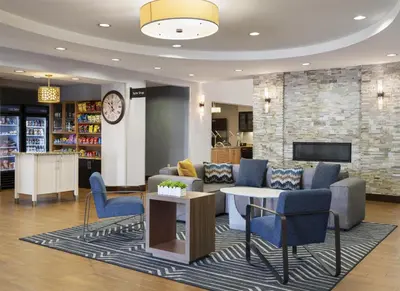 a library with couches and chairs and a clock at Homewood Suites by Hilton Akron/Fairlawn in Akron