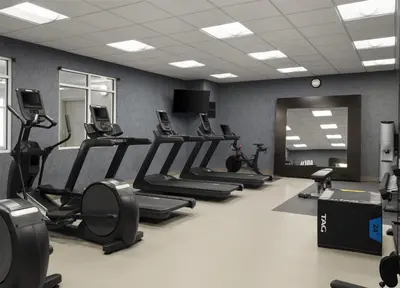 a gym with rows of treadmills and elliptical machines at Homewood Suites by Hilton Akron/Fairlawn in Akron