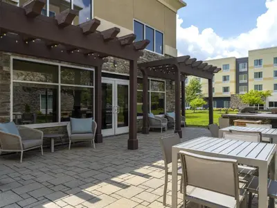 an outdoor patio with a pergola and tables and chairs at Homewood Suites by Hilton Akron/Fairlawn in Akron