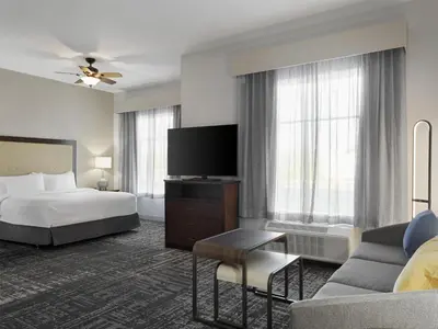a hotel room with a bed and a tv at Homewood Suites by Hilton Akron/Fairlawn in Akron