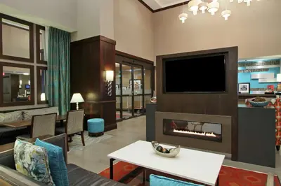 a living room with a fireplace and a tv at Hampton Inn & Suites Columbus/University Area in Columbus