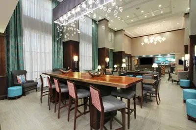 a dining room with a large wooden table and chairs at Hampton Inn & Suites Columbus/University Area in Columbus